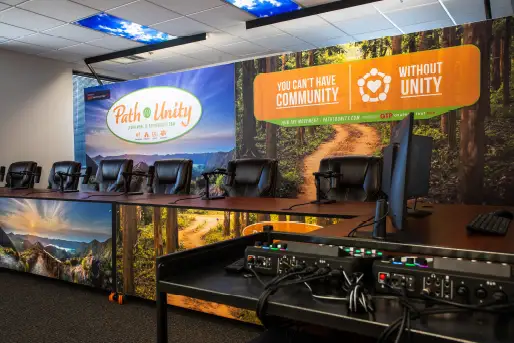 Professional podcast studio at Path to Unity - recording equipment and branded backdrop